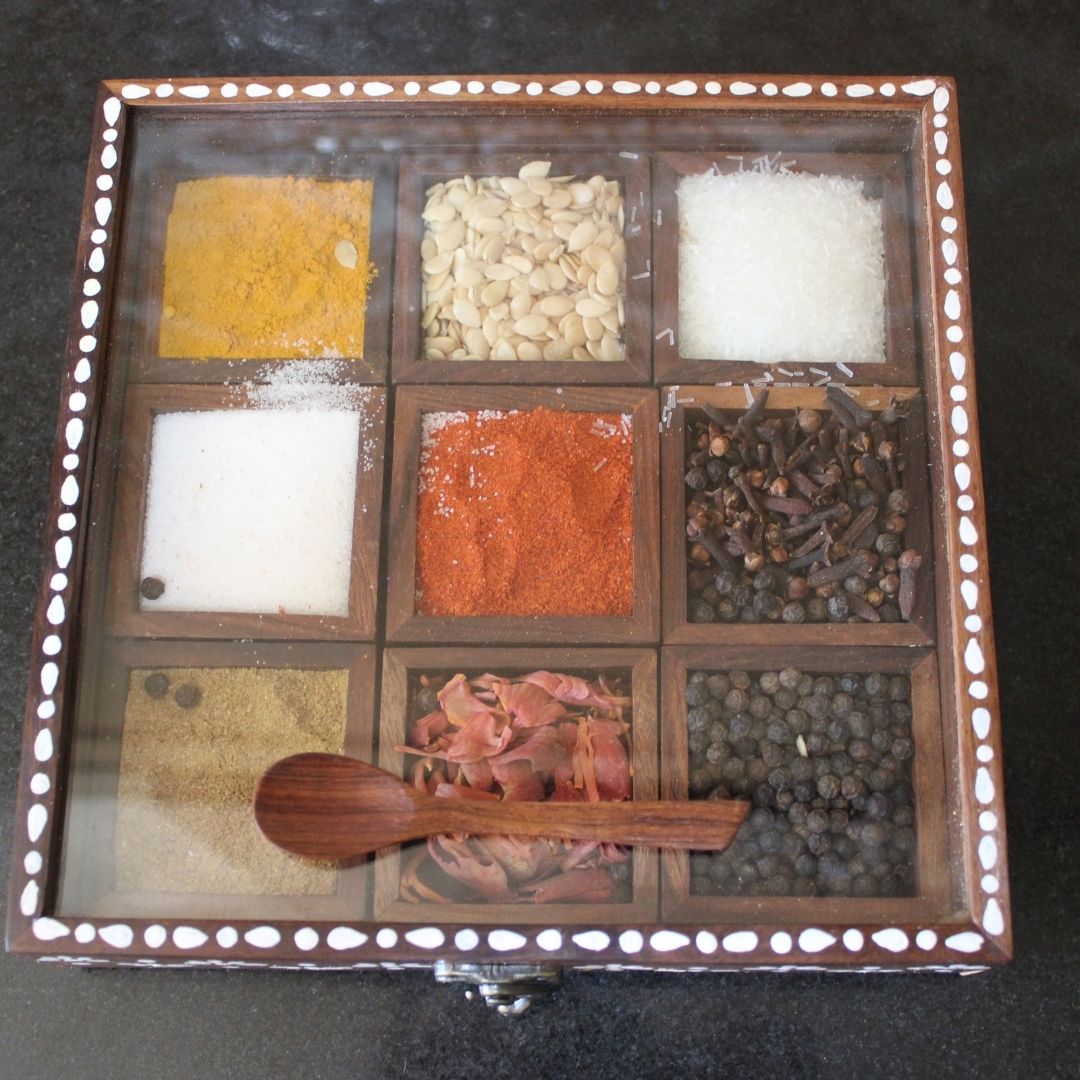 Sheesham wood handcrafted and hand painted wooden spice box / masala dani with nine removable partitions.