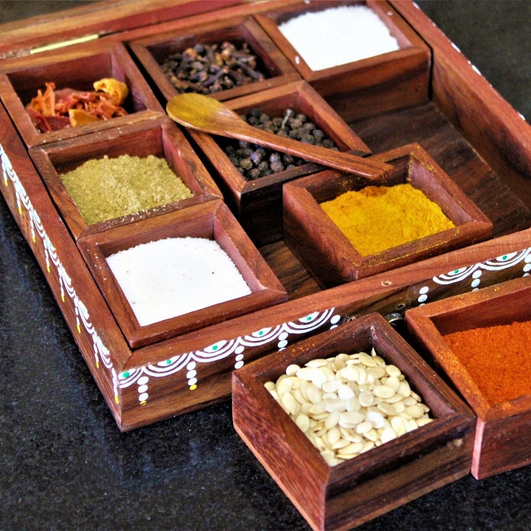 Sheesham wood handcrafted and hand painted wooden spice box / masala dani with nine removable partitions.