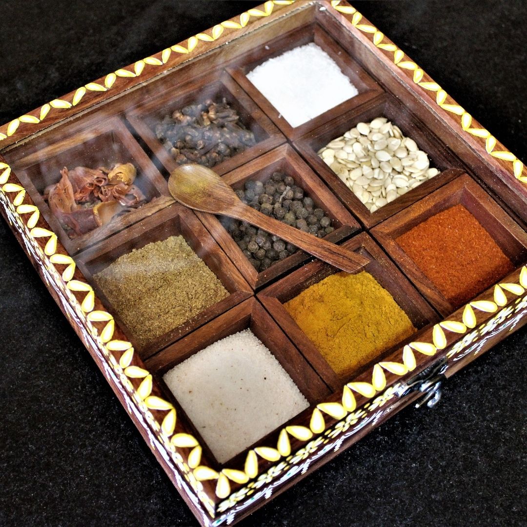 Sheesham wood handcrafted and hand painted wooden spice box / masala dani with nine removable partitions.