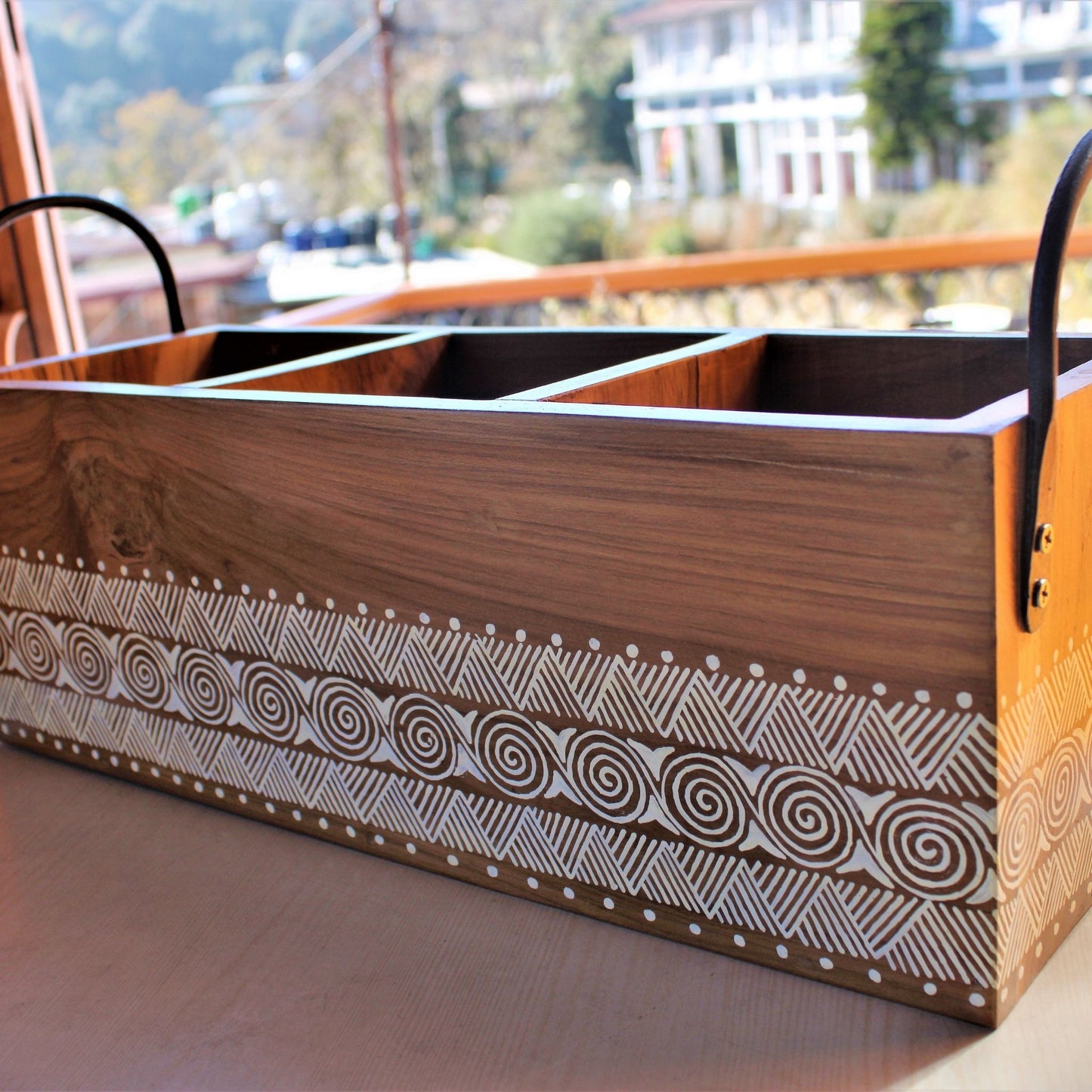 Uttarakhandi Aipan Inspired Hand Painted Sal Wood Planter. Store upto 3 plants in a single planter. Can be used indoors and outdoors. Cast Iron Handles to give an antique look to the planter.