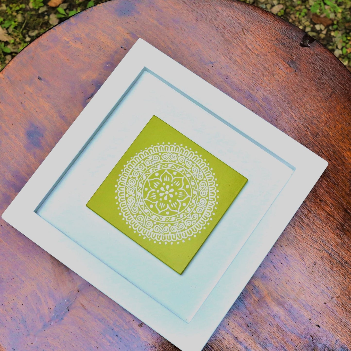 Green And White Colored Hand Painted Kumouni Aipan Inspired Wall Decor in White MDF Frame.