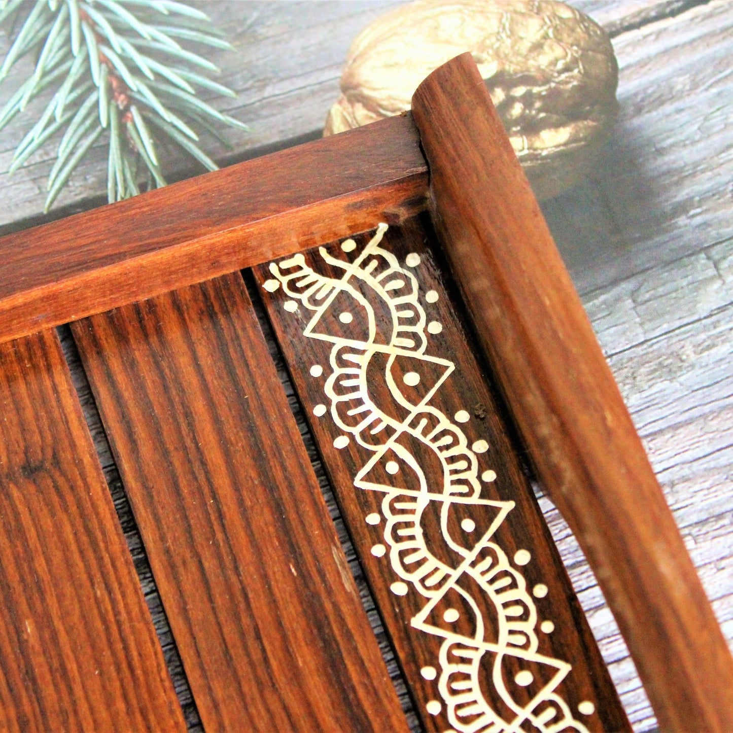 This is beautifully hand painted wooden serving tray for homes. The painting in the centre is inspired by traditional aipan art of kumoun region of rural Uttarakhand.