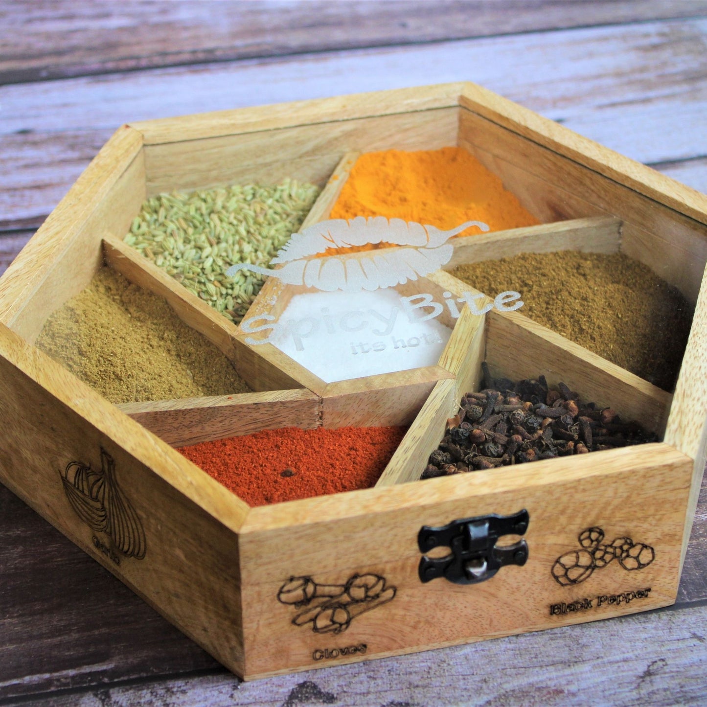 Spicy Bite Engraved Mango Wood Masala Dani or Indian Spice box with seven partitions in hexagon shape.