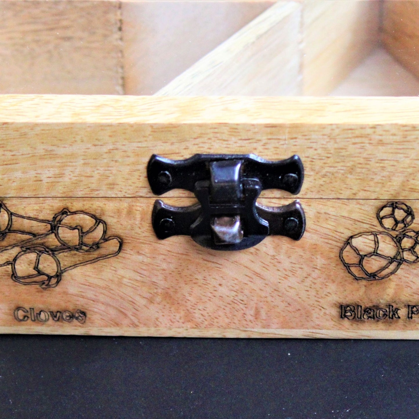 Spicy Bite Engraved Mango Wood Masala Dani or Indian Spice box with seven partitions in hexagon shape. This one shows the laser engraving done on the sides of the box.