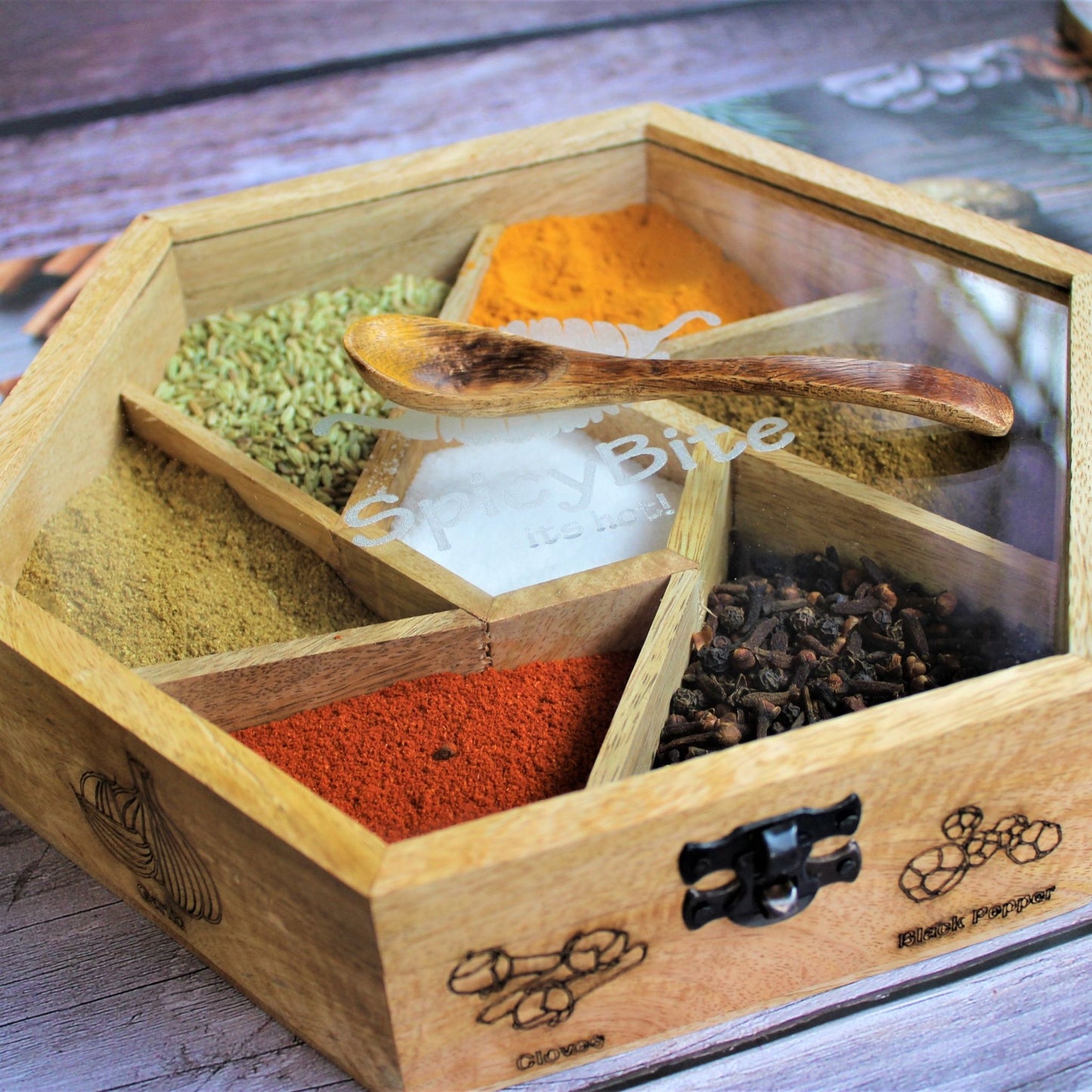 Spicy Bite Engraved Mango Wood Masala Dani or Indian Spice box with seven partitions in hexagon shape.