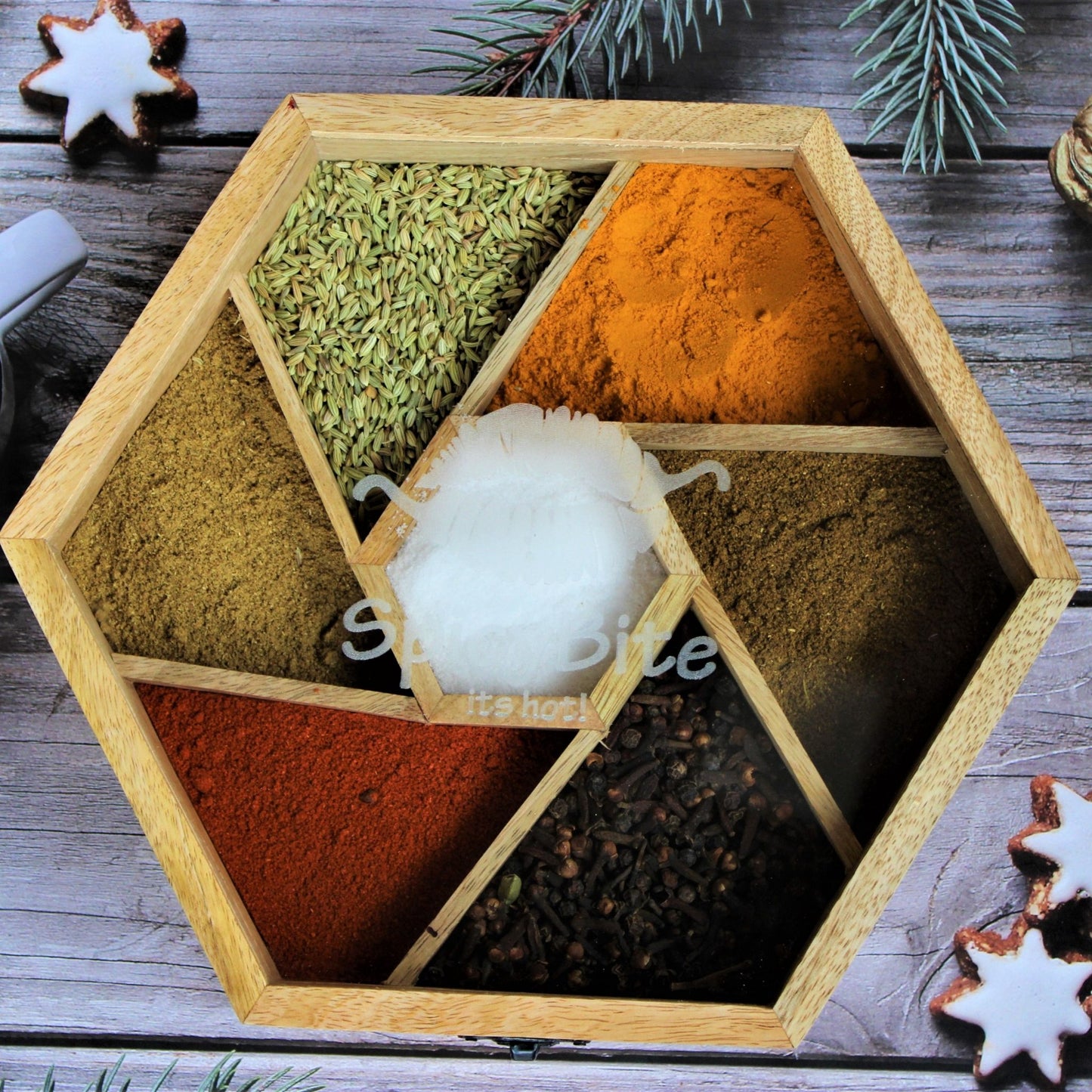 Spicy Bite Engraved Mango Wood Masala Dani or Indian Spice box with seven partitions in hexagon shape.